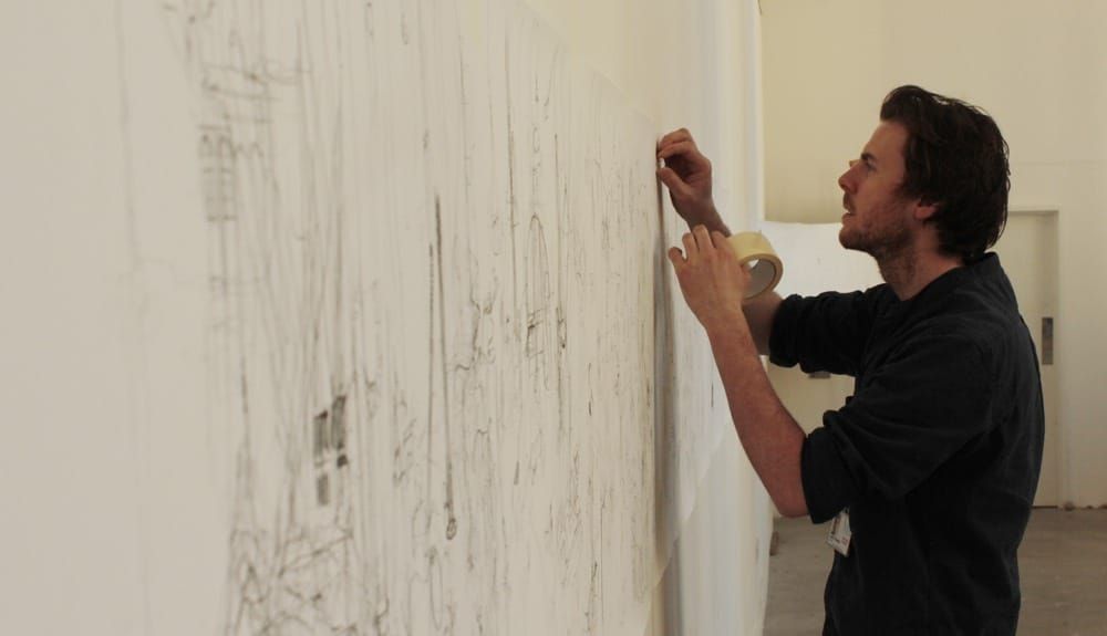 Liam fully unrolls the scroll in his studio towards the end of his residency.